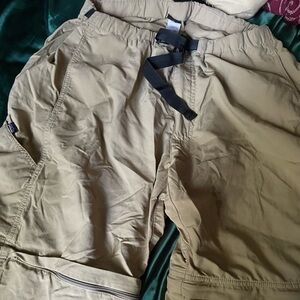 Tan and cream cargo pants with a zipper on the bottom
